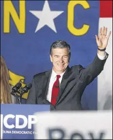  ?? ETHAN HYMAN / TNS ?? Roy Cooper greets supporters during an election party hosted by the North Carolina Democratic Party at the Raleigh Marriott City Center in downtown Raleigh, N.C., on Nov. 8, 2016.