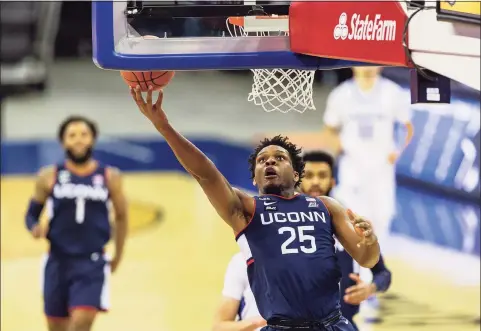  ?? John Peterson / Associated Press ?? UConn’s Josh Carlton (25) drives to the basket for a layup against Creighton on Saturday in Omaha, Neb.