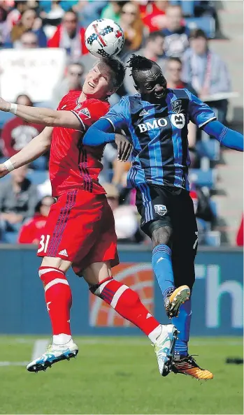  ?? JON DURR/BONGARTS/GETTY IMAGES ?? Bastian Schweinste­iger, left, and the Chicago Fire remain unbeaten in the friendly confines of Toyota Park this season, with Dominic Oduro and the Montreal Impact earning the lone tie.