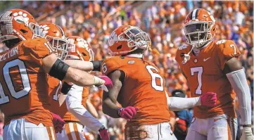  ?? KEN RUINARD/USA TODAY SPORTS ?? Clemson linebacker Mike Jones Jr. (6) celebrates an intercepti­on during last week's win over Syracuse. The Tigers have allowed just 13.5 points per game this season.