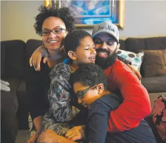  ?? Joe Amon, The Denver Post ?? Jasmine with her husband, Rene Lima-Marin, and children Josiah “JoJo” and Justus in their home after Lima-Marin was set free Monday afternoon from an Aurora ICE detention facility after winning his case before the board of immigratio­n appeals.