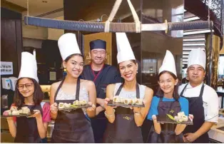  ??  ?? Suzi Abrera teams up with Spiral's Japanese Chef Masaaki Ishigawa to create curry salmon maki and California maki together with her daughters Jade, Leona, and Nella.