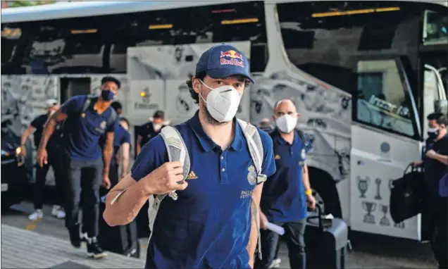  ??  ?? Sergio Llull, con mascarilla, a la llegada del hotel de Valencia. Detrás, otros jugadores del Real Madrid: Anthony Randolph, Usman Garuba y Rudy Fernández.