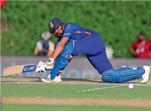  ?? ?? India’s rohit Sharma plays a sweep shot during the warm-up match against australia in Dubai. — ap