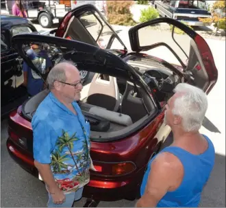  ?? RON SEYMOUR/The Daily Courier ?? Roy Unger of Vernon, left, explains some of the unique features of his 1990 Toyota Sera, a car with gull-wing doors that was made only for the Japanese market, at the Boyd’s Father’s Day Car Show in Kelowna. See page A2 for more photos from Sunday’s...