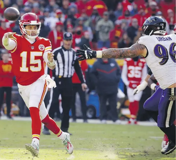  ?? CHARLIE RIEDEL/THE ASSOCIATED PRESS ?? Kansas City Chiefs quarterbac­k Patrick Mahomes, being pursued by Baltimore Ravens defensive end Brent Urban Sunday at Arrowhead Stadium, threw for 377 yards and two touchdowns as the Chiefs clinched a playoff spot with a 27-24 overtime win.