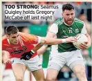  ??  ?? TOO STRONG: Seamus Quigley holds Gregory McCabe off last night