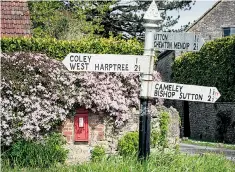  ??  ?? Miles from Hinton Blewett: beside the finger-post, one of Britain’s 100,000 post boxes