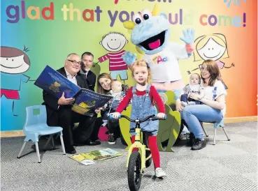  ??  ?? Ace initiative Councillor David Watson, SLLC general manager SLLC Gerry Campbell, baby Max Lannon with sister Grace on bike and baby Ollie Adam at the Tiny ACE launch day with mascot Scorch