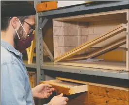  ??  ?? Zack Fealk of Detroit shows off a toolbox he made during the class.