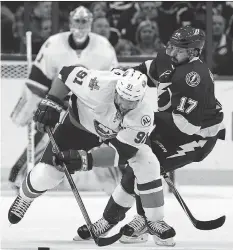  ?? MIKE CARLSON/GETTY IMAGES ?? John Tavares of the New York Islanders dodges a check from Alex Killorn of the Tampa Bay Lightning during the first period in Game 1 of the Eastern Conference Second Round.