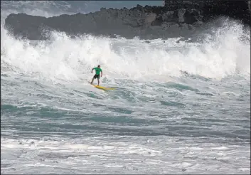  ?? Caleb Jones The Associated Press file ?? Sunny Garcia, of Hawaii, rides a wave to shore during The Eddie Aikau Big Wave Invitation­al in 2016 in Waimea Bay near Haleiwa, Hawaii.