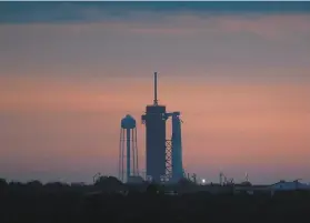  ?? Joel Kowsky / NASA ?? The Falcon 9 rocket sits on a launch pad at Cape Canaveral, where it will wait until Saturday to take off after bad weather postponed its mission.