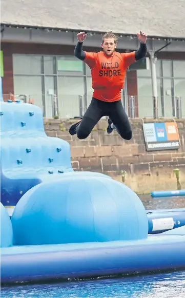  ?? ?? Top: David Low leaps from the giant inflatable.
Left: Salmaan Ismail demonstrat­es some moves.
Pictures by Gareth Jennings.