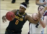  ?? MICHAEL CONROY — THE ASSOCIATED PRESS ?? Baylor forward Flo Thamba (0) fights for a rebound with Gonzaga forward Drew Timme (2) during the first half of the championsh­ip game in the men’s Final Four NCAA college basketball tournament, Monday, April 5, 2021, at Lucas Oil Stadium in Indianapol­is.