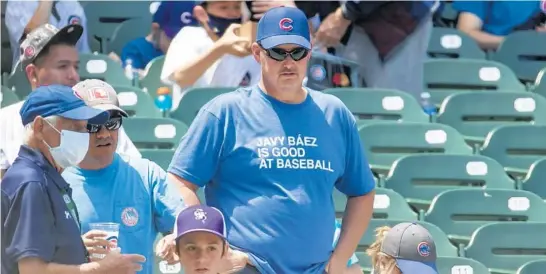  ?? BRIAN CASSELLA / CHICAGO TRIBUNE ?? A fan wears an Obvious Shirts design on June 2 at Wrigley Field.