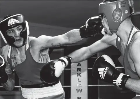  ??  ?? Dean Walsh of St Ibar’s Boxing Club in Wexford lands a straight left on Arklow’s Sean Crowley during the Arklow Boxing Club’s annual tournament last week. Photo: Garry O’Neill