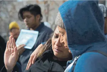  ?? Hyoung Chang, The Denver Post ?? Yessenia Martinez, right, comforts her friend Guadalupe “Lupe” Lopez on Jan. 29 in front of the Immigratio­n Court in Denver. Lopez and her husband are facing the threat of deportatio­n.