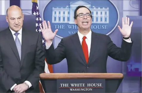  ?? Carolyn Kaster/Associated Press ?? Treasury Secretary Steven Mnuchin, right, joined by national economic director Gary Cohn, speaks in the briefing room of the White House in Washington, D.C.