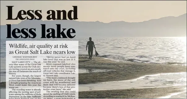  ?? (AP/Rick Bowmer) ?? A man walks along a sand bar at the receding edge of the Great Salt Lake.