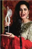  ??  ?? Bollywood Actress Katrina Kaif holds an award on stage.