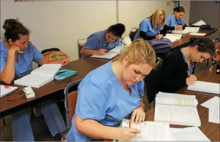  ?? DIGITAL FIRST MEDIA FILE PHOTO ?? In this file photo, medical assistant students work in a classroom at Antonelli Medical and Profession­al Institute. The school announced it would close in 2017 — first in August — a decision that was quickly reversed. The second announceme­nt came at...