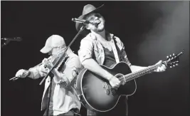  ?? Herald photo by Ian Martens @IMartensHe­rald ?? Albertan country star Brett Kissel performs his hit “Something You Just Don’t Forget” as part of the PBR Kick Off Concert this week at the Enmax Centre.