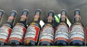  ?? ASSOCIATED PRESS FILE PHOTO ?? Bottles of Budweiser beer are displayed in a shop window in London.