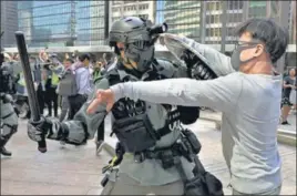  ??  ?? ■
A riot police officer scuffles with an anti-government protester in Hong Kong’s Central district.