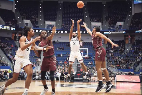  ?? Jessica Hill / Associated Press ?? UConn’s R.J. Cole makes a basket over Maryland-Eastern Shore’s Nathaniel Pollard Jr., right, on Tuesday in Hartford.