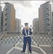  ?? (AP/Hiro Komae) ?? A guard stands in front of a fence to close off a constructi­on site for the athletes’ village to be used during the Tokyo 2020 Olympic and Paralympic Games in Tokyo.