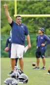  ?? THE ASSOCIATED PRESS ?? Tennessee Titans coach Mike Vrabel talks to players during the first day of training camp Thursday in Nashville.