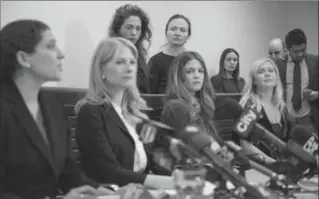  ?? CHRISTOPHE­R KATSAROV, THE CANADIAN PRESS ?? Lawyers Alexi Wood, left, and Tatha Swann, second from left, and plaintiffs Hannah Miller, Patricia Fagan, Diana Bentley and Kristin Booth attend a news conference after filing their lawsuits.