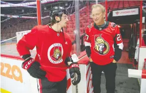  ?? WAYNE CUDDINGTON / POSTMEDIA NEWS FILES ?? Eugene Melnyk chats with Ottawa Senators defenceman Thomas Chabot.