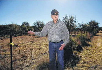  ?? Photos by Kin Man Hui / Staff photograph­er ?? Henry Sauer uses a yellow marker to show where a pipeline could cross onto his property south of Fredericks­burg. He’s among the landowners scrambling to learn their rights and what they can do about the Permian Highway pipeline.