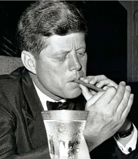  ??  ?? Puffing away: JFK lights up at a Washington banquet