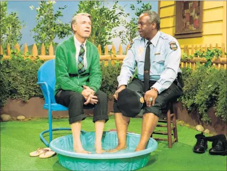  ?? John Beale ?? FRED ROGERS, left, kicks back with Officer Clemmons, played by François Scarboroug­h Clemmons, on “Mister Rogers’ Neighborho­od.”