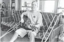  ?? 12 NEWS ?? Ken Danna plays the guitar at his home in Mojave County.