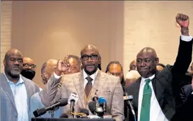  ?? KEREM YUCEL / GETTY IMAGES ?? George Floyd's brother Philonise Floyd, center, speaks flanked by the Rev. Al Sharpton, second from left, and Attorney Ben Crump, right, during a press conference following the verdict in the trial of former Police Officer Derek Chauvin in Minneapoli­s Tuesday.