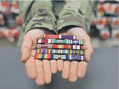  ?? PHOTOS BY CHRIS PEDOTA/ USA TODAY NETWORK ?? Every fallen soldier at Dover Air Force Base’s Mortuary Affairs Operations facility receives a final uniform with decoration­s and insignia that are placed above the heart.