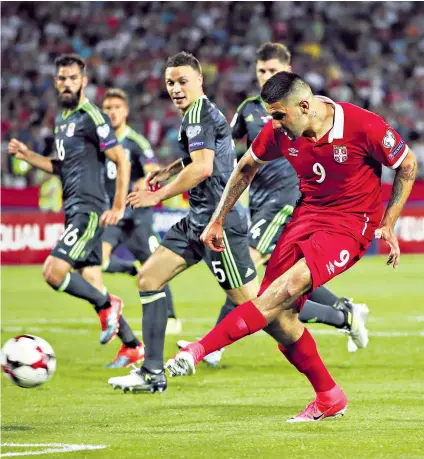  ??  ?? Heartbreak­er: Serbia striker Aleksandar Mitrovic slots home the equaliser against Wales in Belgrade