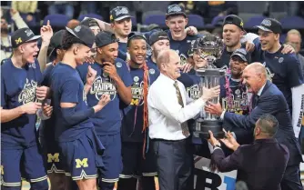  ?? AMBER SEARLS, USA TODAY SPORTS ?? Since their plane skidded off the runway, John Beilein and Michigan have been crowned Big Ten tournament champions, above, and won two NCAA tournament games.