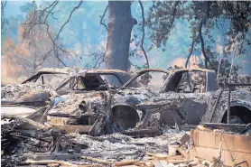 ?? PAUL KITAGAKI JR./THE SACRAMENTO BEE ?? Vehicles and homes on Wolf Creek Road were destroyed in the Pawnee Fire in Lake County as residents evacuated and the fire continued to burn out of control.