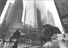  ?? Canadian Press photo ?? People walk in Toronto’s financial district in this 2012 file photo. As government­s roll out plans to reopen the economy in the wake of the COVID-19 pandemic, experts say individual Canadians need to update their own financial plan to move forward, too.