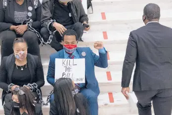  ?? BEN GRAY/AP ?? Protesters opposed to changes in Georgia’s voting laws at the State Capitol in Atlanta on Monday. Many proposed changes in voting across the country would disproport­ionately affect groups that historical­ly vote for Democrats.