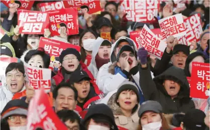  ??  ?? SEOUL: South Korean protesters shout slogans during a rally calling for South Korean President Park Geun-hye to step down in Seoul, South Korea yesterday. — AP