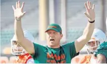  ?? SUSAN STOCKER/SOUTH FLORIDA SUN SENTINEL ?? University of Miami offensive coordinato­r Rhett Lashlee raises his hands during practice.