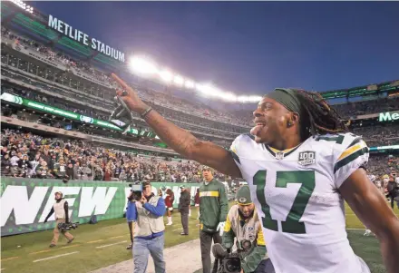  ?? MIKE DE SISTI / MILWAUKEE JOURNAL SENTINEL ?? Davante Adams of the Green Bay Packers responds to the fans after the Packers’ 44-38 overtime win against the New York Jets on Dec. 23 at MetLife Stadium in East Rutherford, New Jersey.