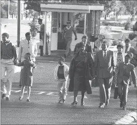  ?? Picture: Benny Gool/ Oryx Media ?? HAND OF COMFORT: Winnie Madikizela- Mandela with her step son Makgatho Mandela and other members of the Mandela family leave Victor Verster Prison in Paarl. With them is Dullah Omar (left) in a grey coat.