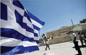  ??  ?? Blowing in the wind: A Greek flag at Syntagma square in front of the Greek Parliament in Athens. Now that Greece is headed for fresh elections next month, voters will have to do their maths again – whether the country should continue down the path of...